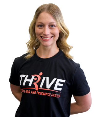 Woman smiling in a black THRIVE T-shirt with her hands behind her back on a white background