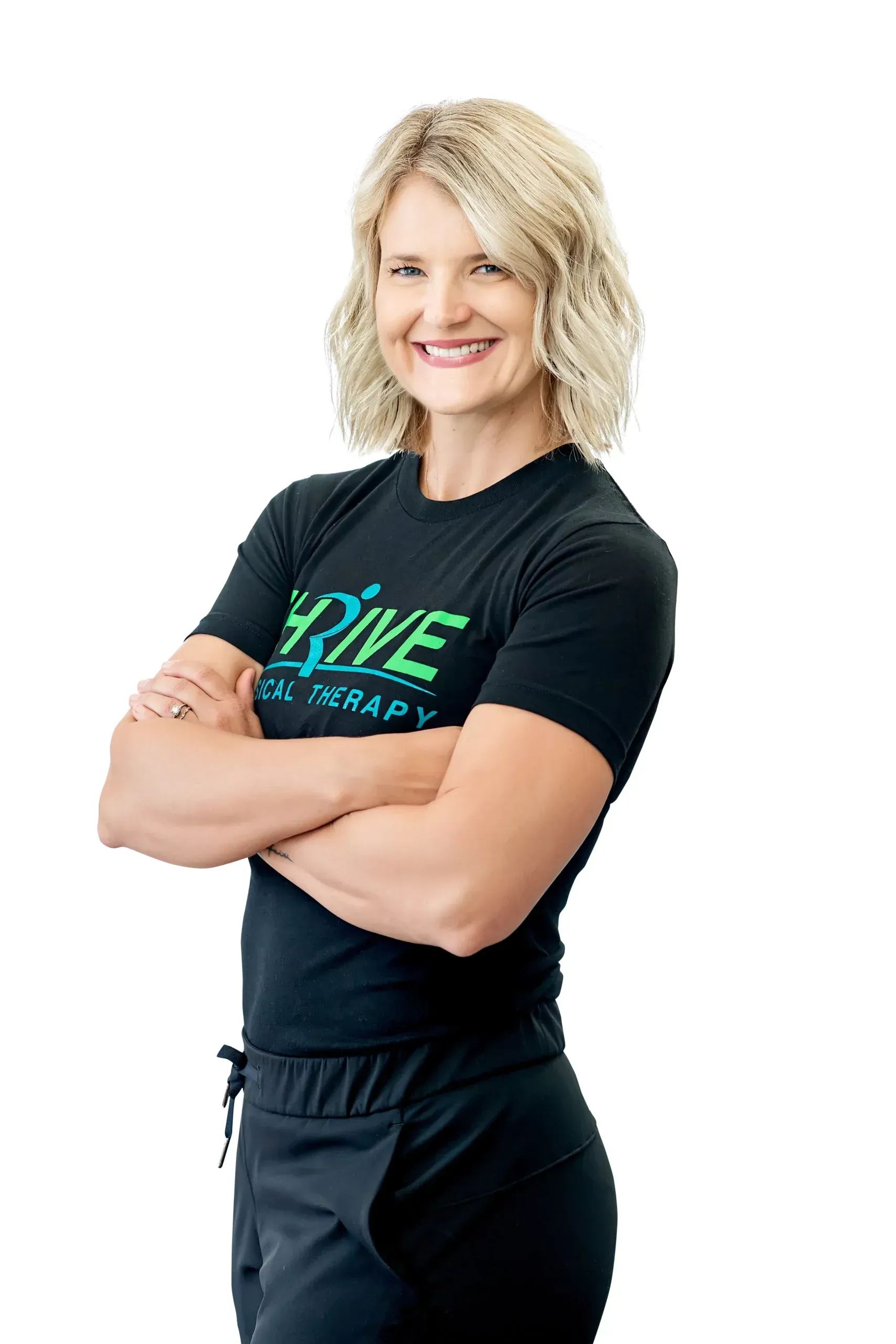 Smiling woman with crossed arms in a black T-shirt and pants on a white background