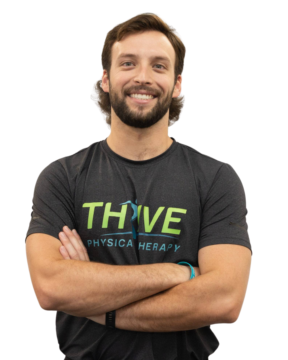 Smiling man in a black Thrive Physical Therapy T-shirt, standing with arms crossed against a white background