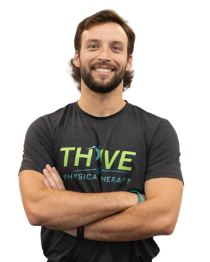 Smiling person with crossed arms wearing a black THIVE Physical Therapy T-shirt on a white background