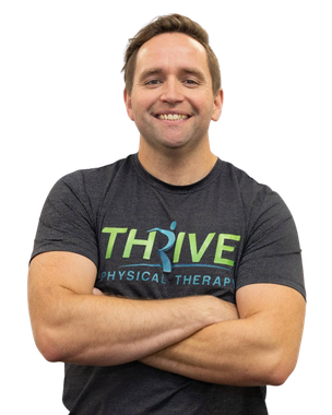 Smiling person with arms crossed wearing a THRIVE Physical Therapy T-shirt on a white background