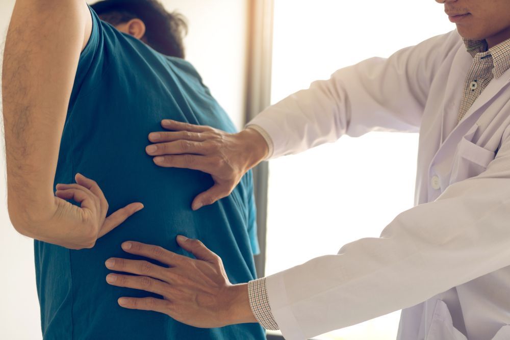 Doctor examining a patient’s chest and abdomen in a clinic