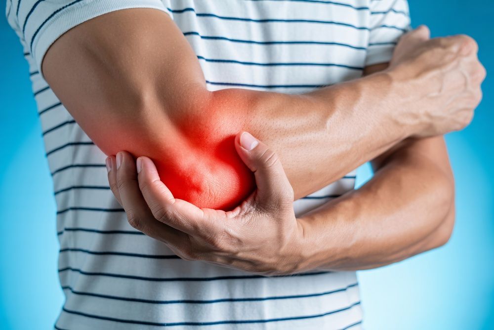 Person holding an elbow with red pain highlight, suggesting elbow injury or inflammation