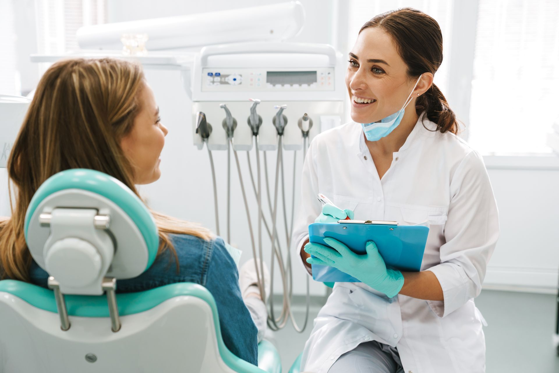 A dentist is talking to a patient.