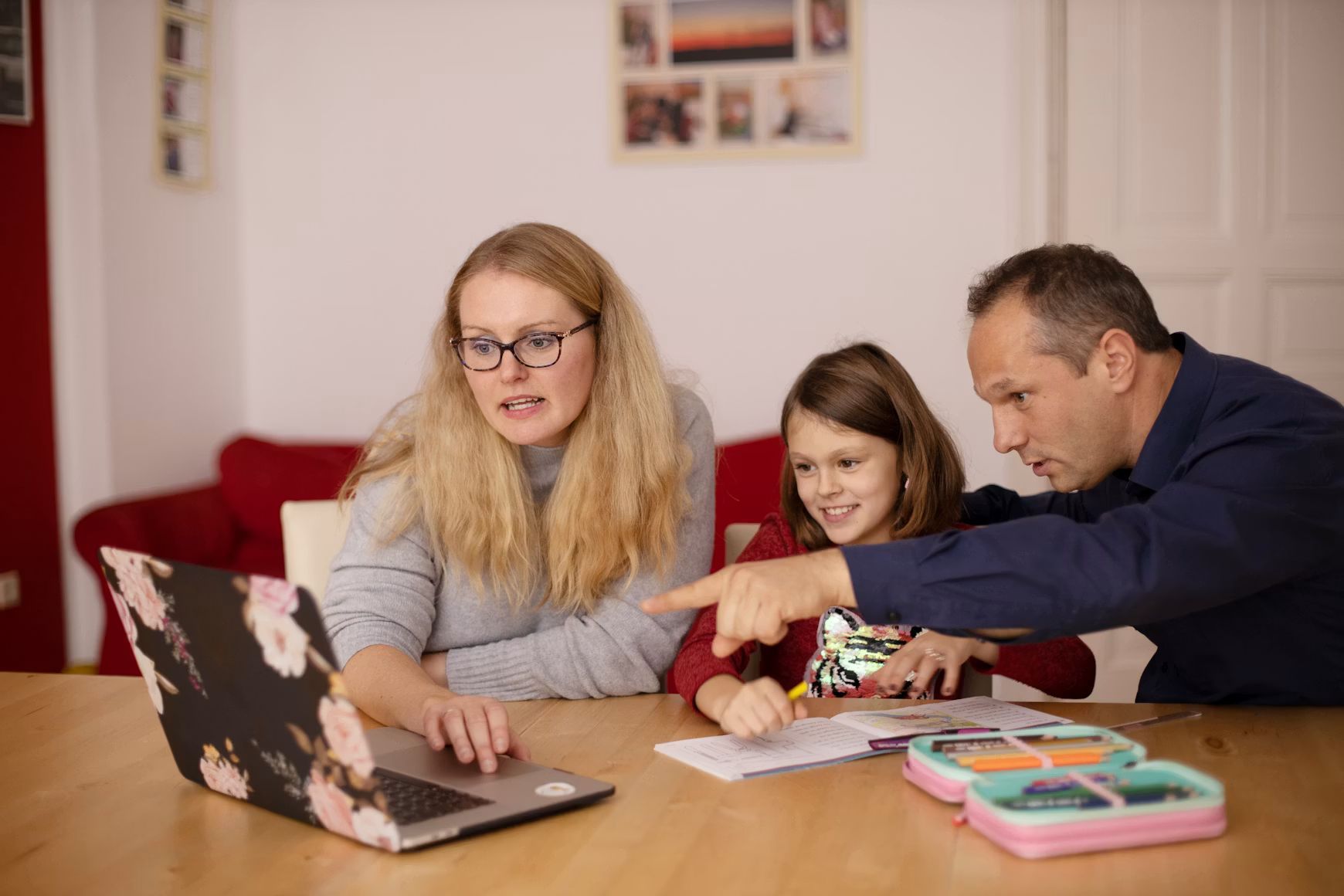 Parents with child look at laptop