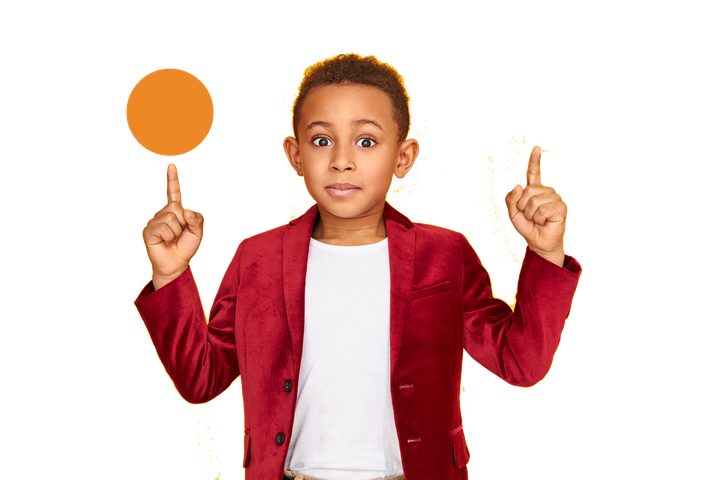 A young boy in a red jacket is pointing up at a circle.