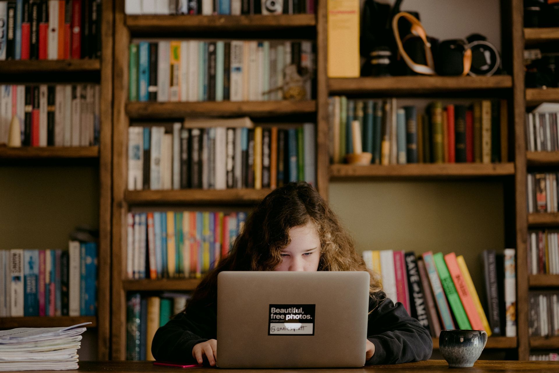 child browsing on laptop