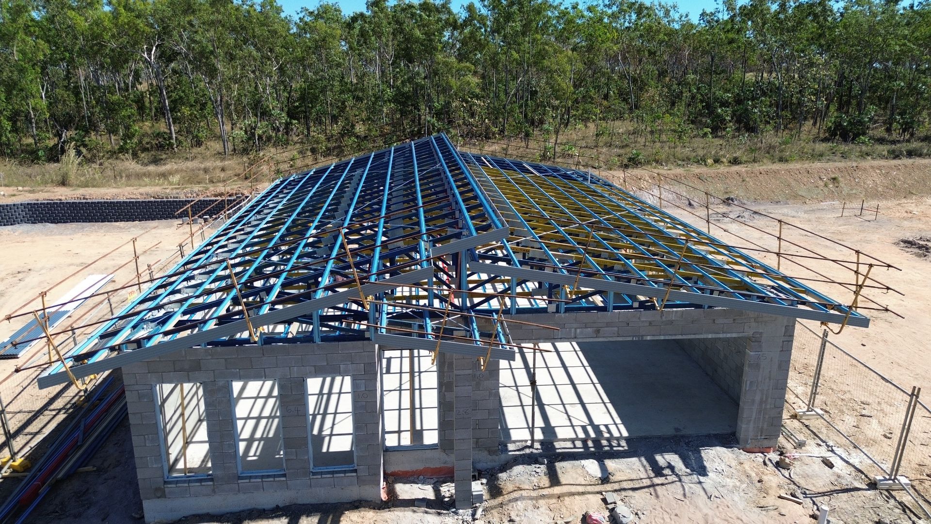 Metal Roof Trusses on a Small Concrete House Under Construction — Tick of Approval Pty Ltd in Berrimah, NT