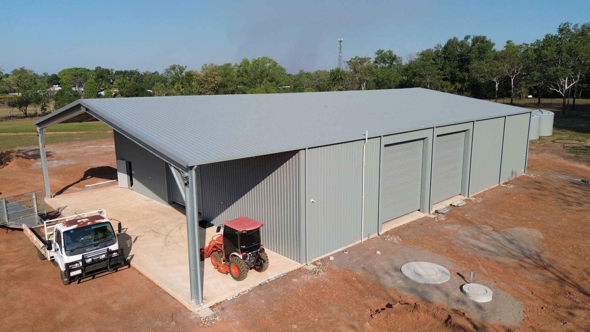 Large Metal Shed With a Sloped Roof on a Dirt Lot — Tick of Approval Pty Ltd in Berrimah, NT