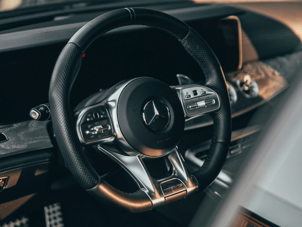 Mercedes-Benz steering wheel and dashboard inside a luxury car interior