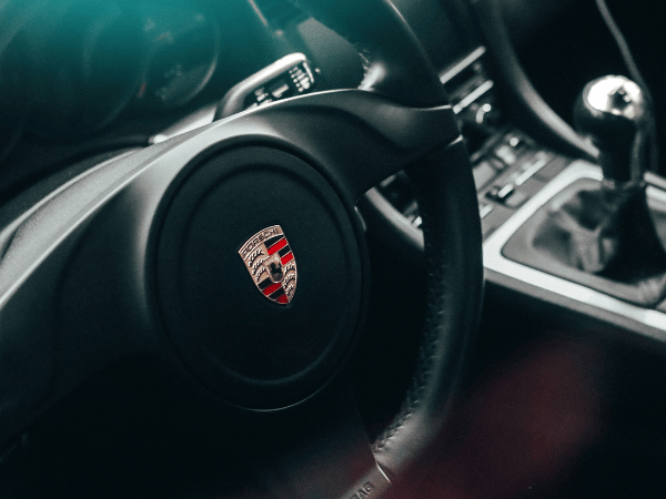 Porsche steering wheel and center console inside a luxury sports car