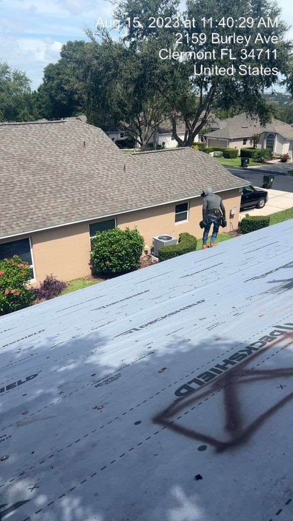 Roofer on a roof, working on a house in Clermont, Florida.