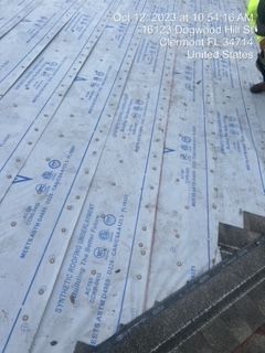 Synthetic roofing underlayment being installed on a roof in Clermont, FL.