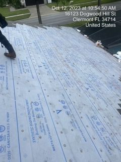 Person on a roof with synthetic roofing material. Location: Clermont, FL.