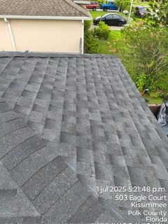 Gray asphalt shingle roof. Location 503 Eagle Court, Kissimmee, Florida.