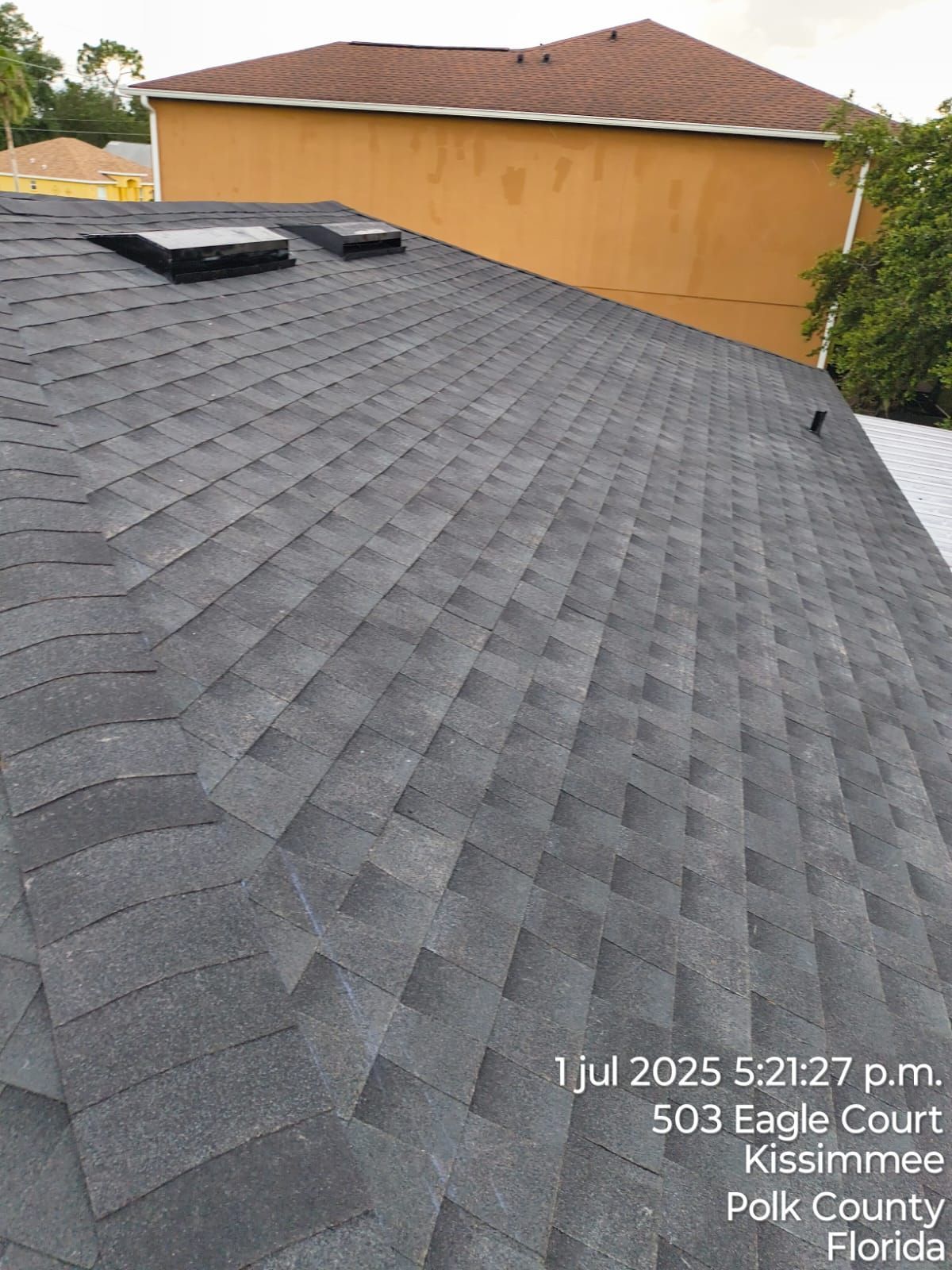 Dark asphalt shingle roof with skylights, Kissimmee, Florida.