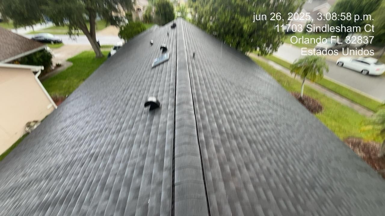 A dark shingled roof with a central ridge. Date and address are visible in the upper right.
