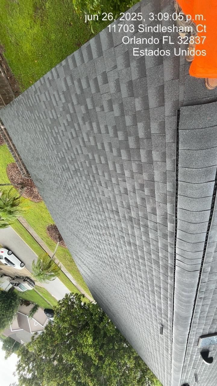 View of a gray shingle roof in Orlando, Florida. Date and address information at the top.