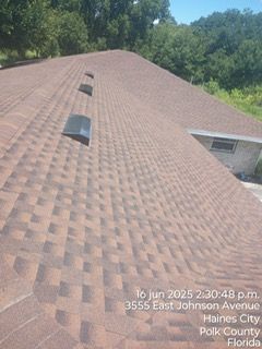 Brown shingled roof with vents. Text: 3555 East Johnson Avenue, Haines City, Florida.