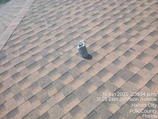 Roof with brown and black shingles, a vent, Haines City, Florida.