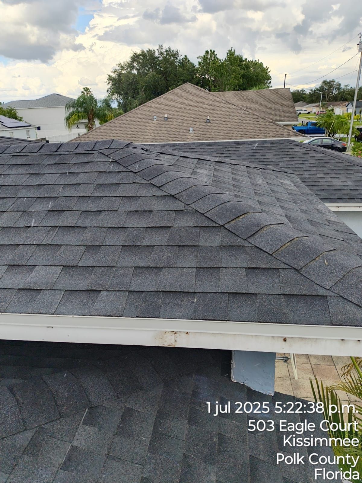 Roofs of houses, dark shingles, blue sky, Kissimmee, Florida.