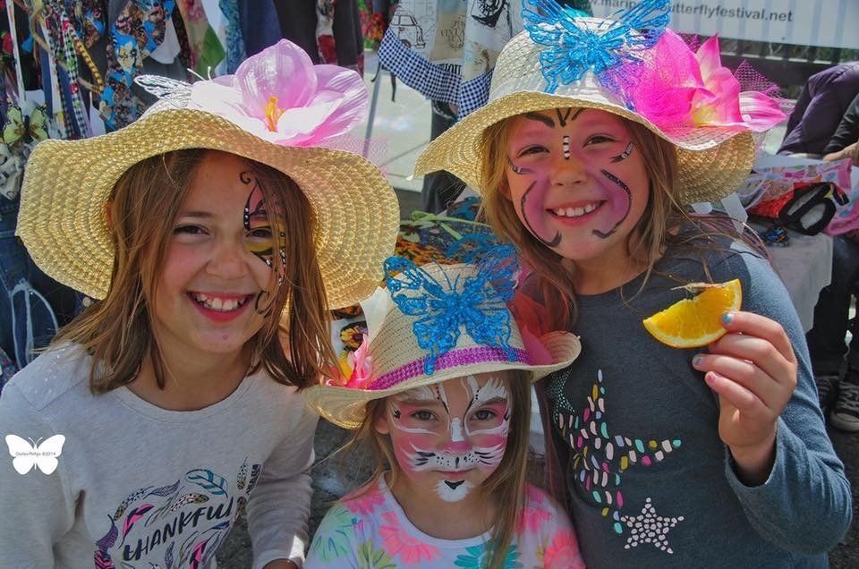 children smiling holding butterflies
