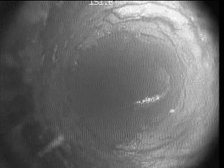 A grayscale image of a large crater on a celestial body