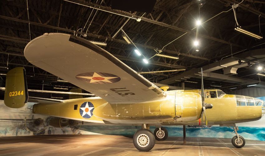 A us airplane is parked inside of a building
