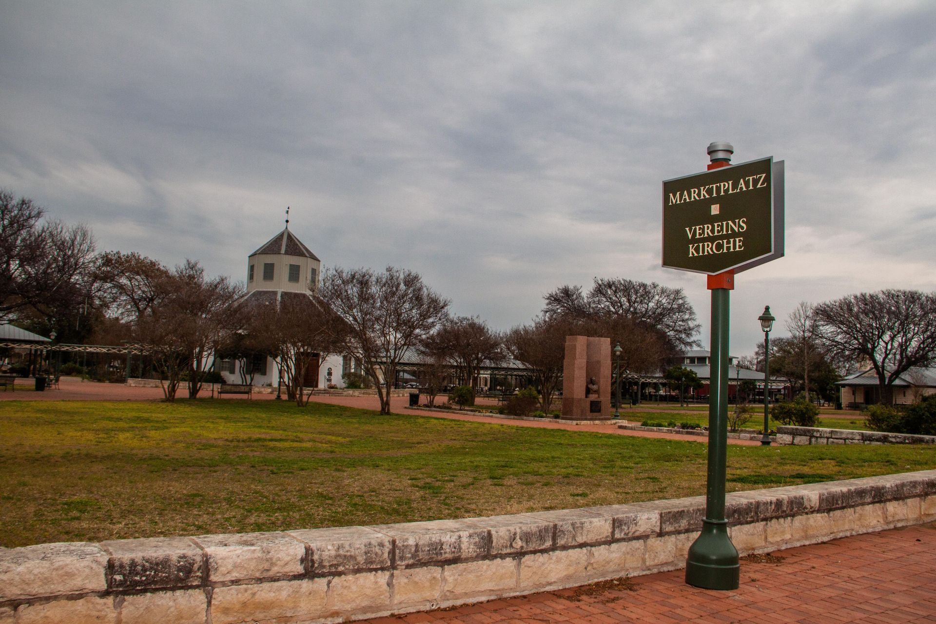 A green pole with a sign on it that says u.s. post office