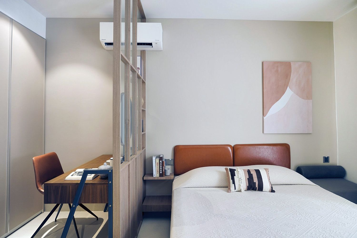 Modern bedroom with bed, desk, chair, wall art, and a partial glass partition