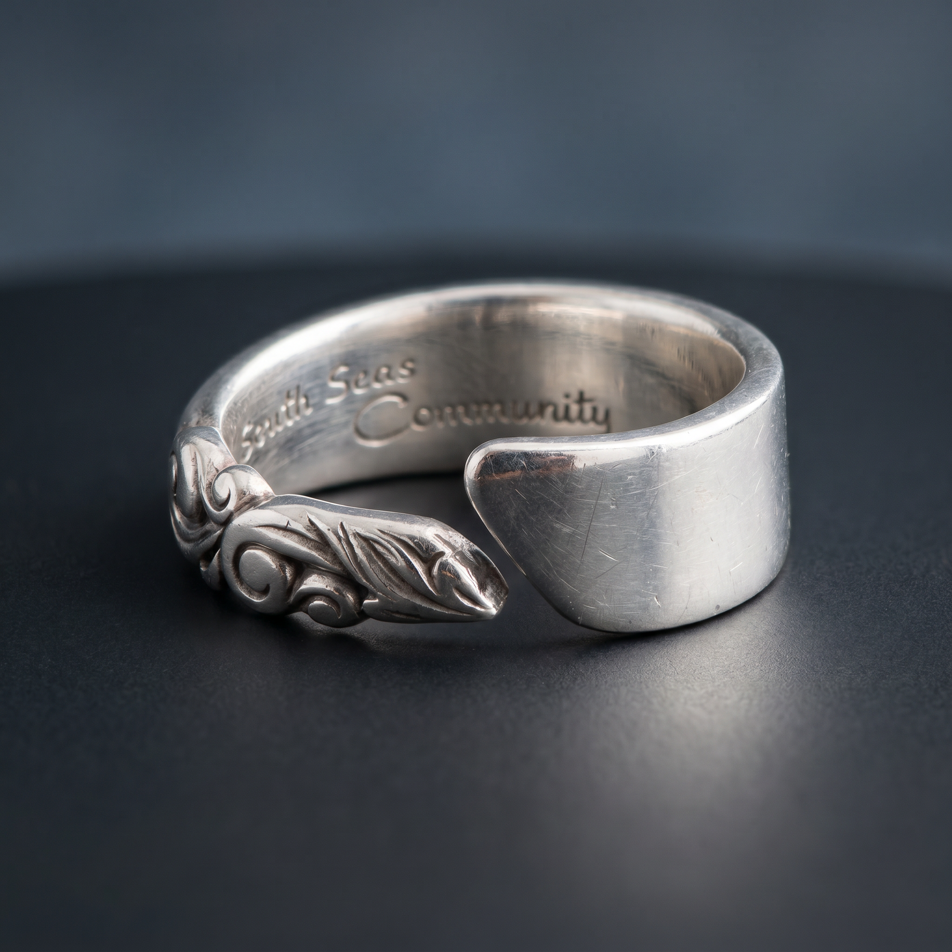 A close up studio shot of a silver ring
