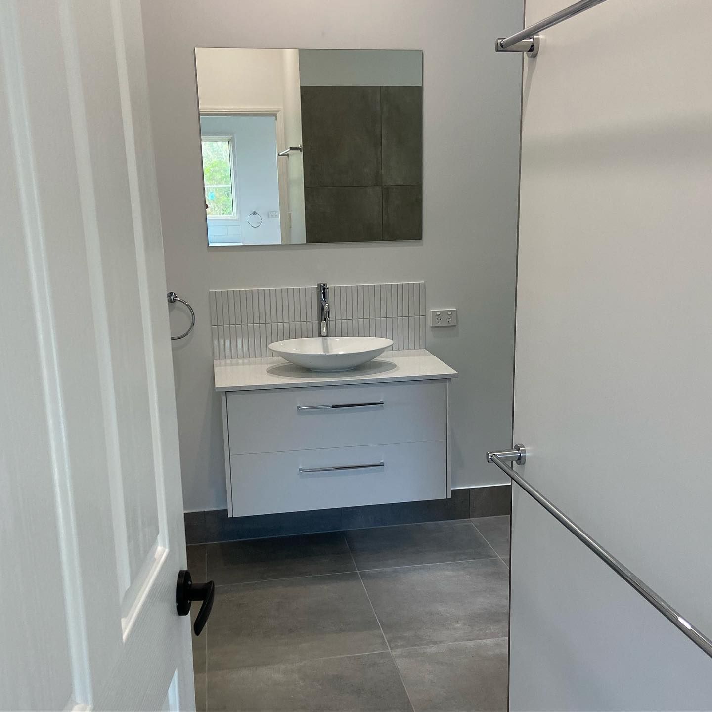 A Bathroom With a Sink, Mirror and Towel Rack — NGK Constructions In Freshwater, QLD