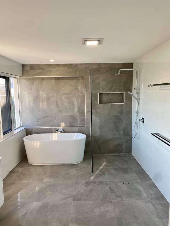 A Bathroom With a Bathtub and a Walk in Shower — NGK Constructions In Freshwater, QLD