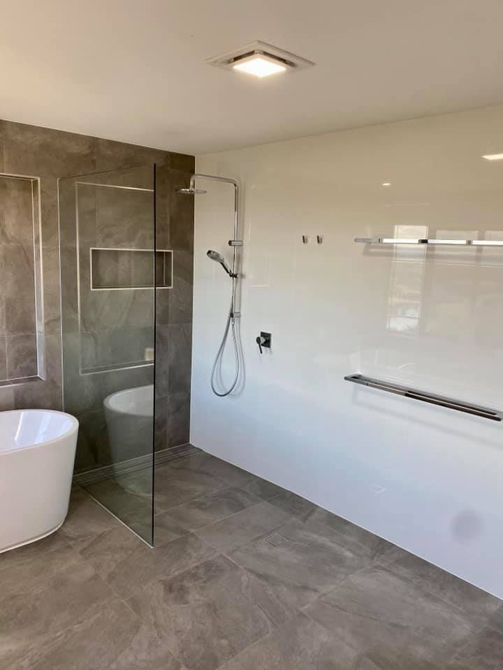 A Bathroom With a Bathtub and a Walk in Shower — NGK Constructions In Freshwater, QLD