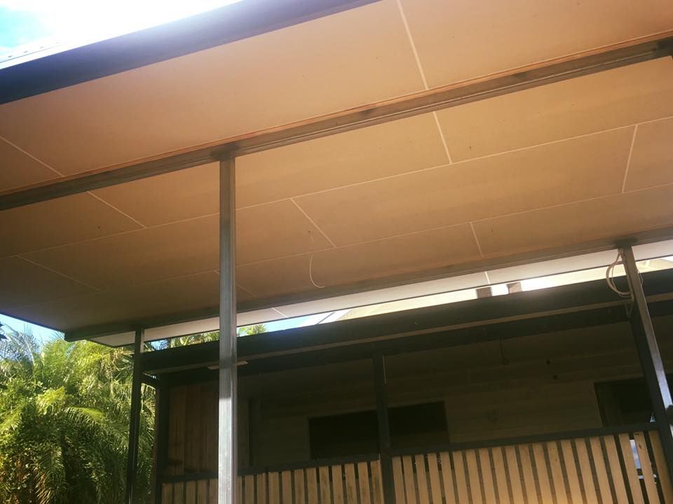 The Roof of a House With a Covered Porch and a Fence — NGK Constructions In Freshwater, QLD