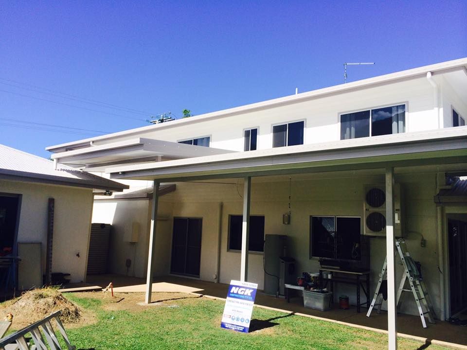 A House With a Covered Porch and a Sign in Front of It — NGK Constructions In Freshwater, QLD