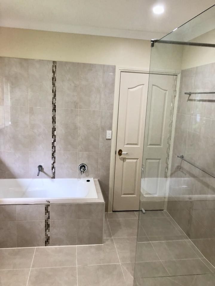 A Bathroom With a Bathtub and a Walk in Shower — NGK Constructions In Freshwater, QLD
