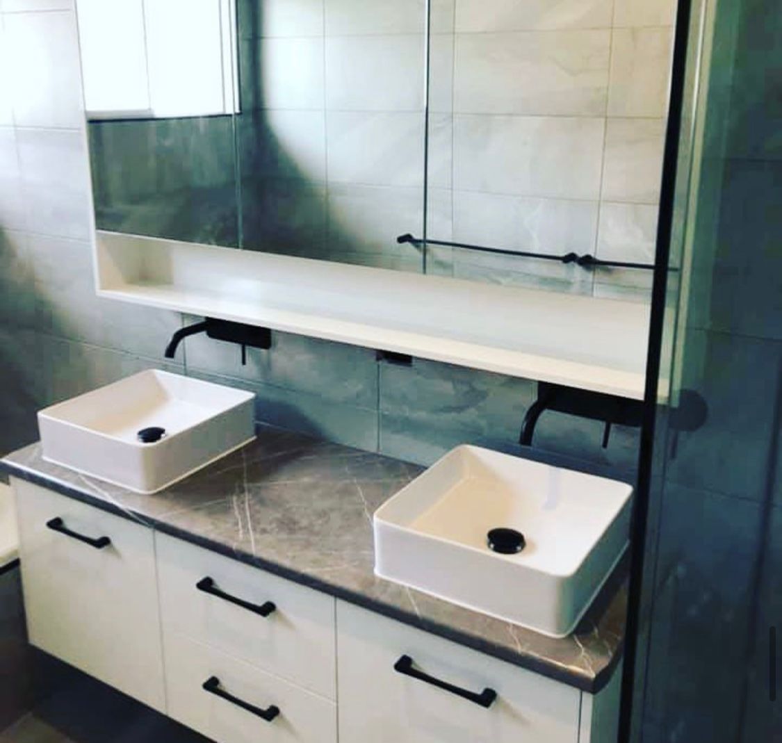 A Bathroom With Two Sinks and a Mirror — NGK Constructions In Freshwater, QLD