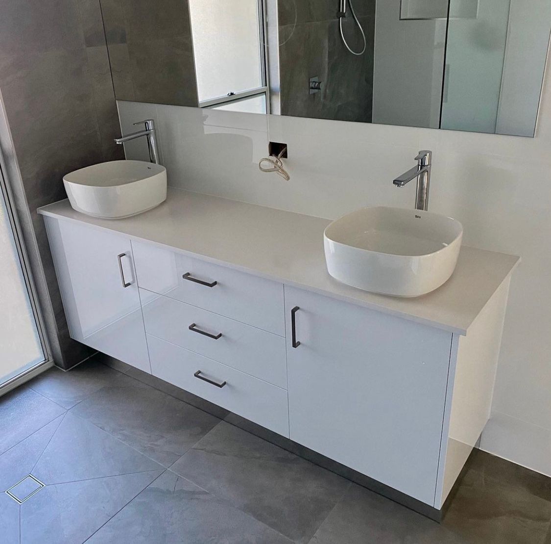 A Bathroom With Two Sinks and a Mirror — NGK Constructions In Freshwater, QLD