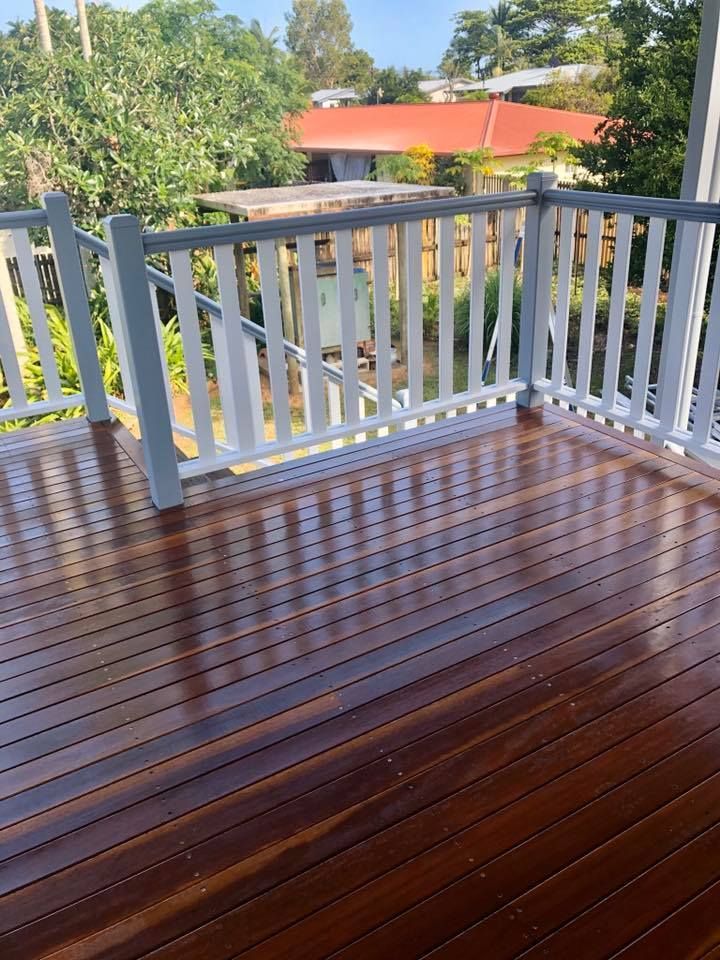 A Wooden Deck With a White Railing and a View of a House — NGK Constructions In Freshwater, QLD