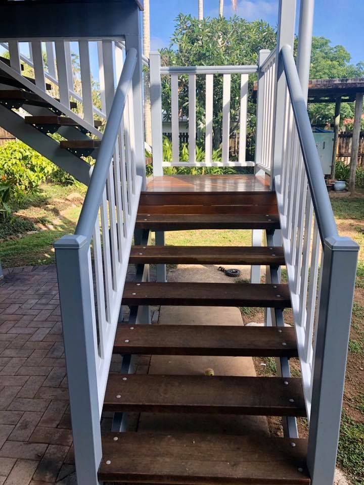 A Set of Wooden Stairs With a White Railing — NGK Constructions In Freshwater, QLD