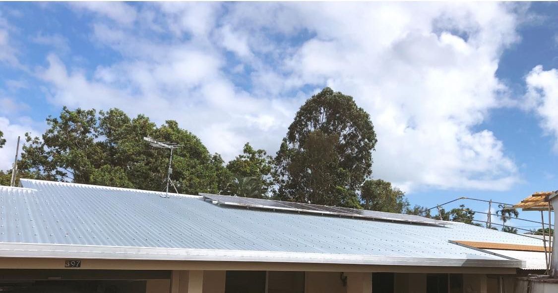 A Roof With Trees in the Background and a Blue Sky With Clouds — NGK Constructions In Freshwater, QLD