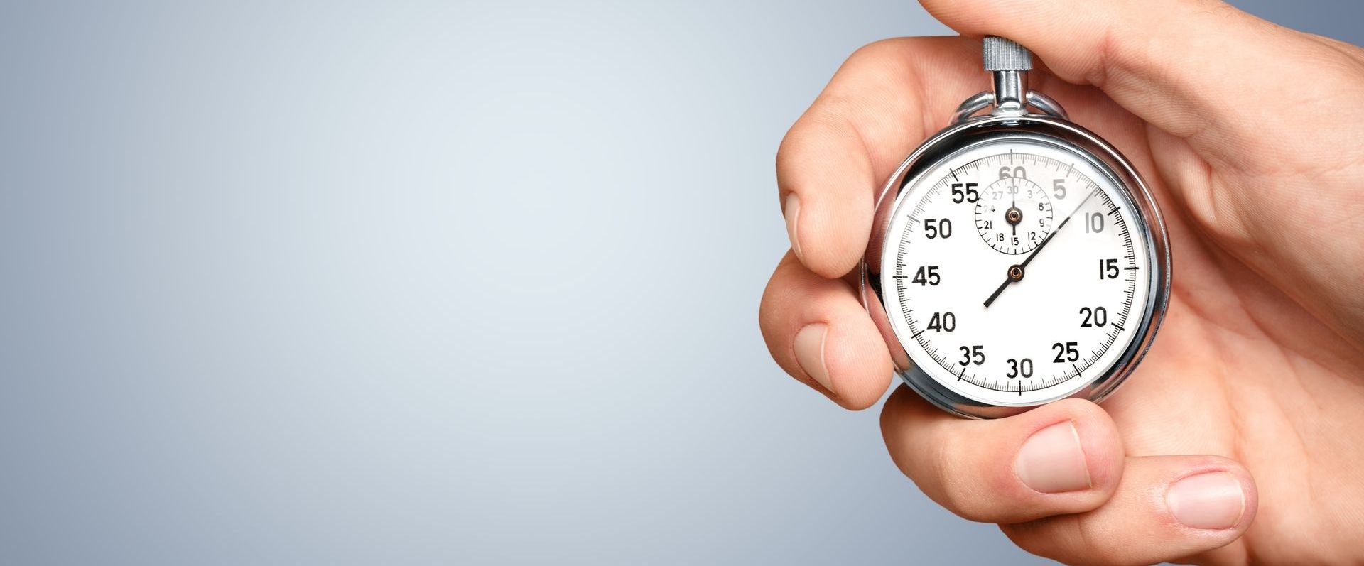 person holding old fashioned stop watch