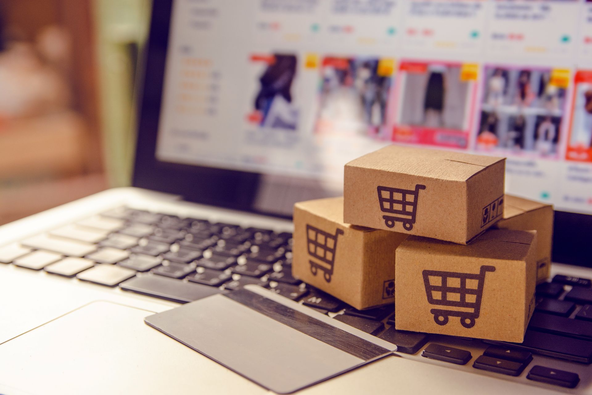 Computer with credit card and online store in backgroung