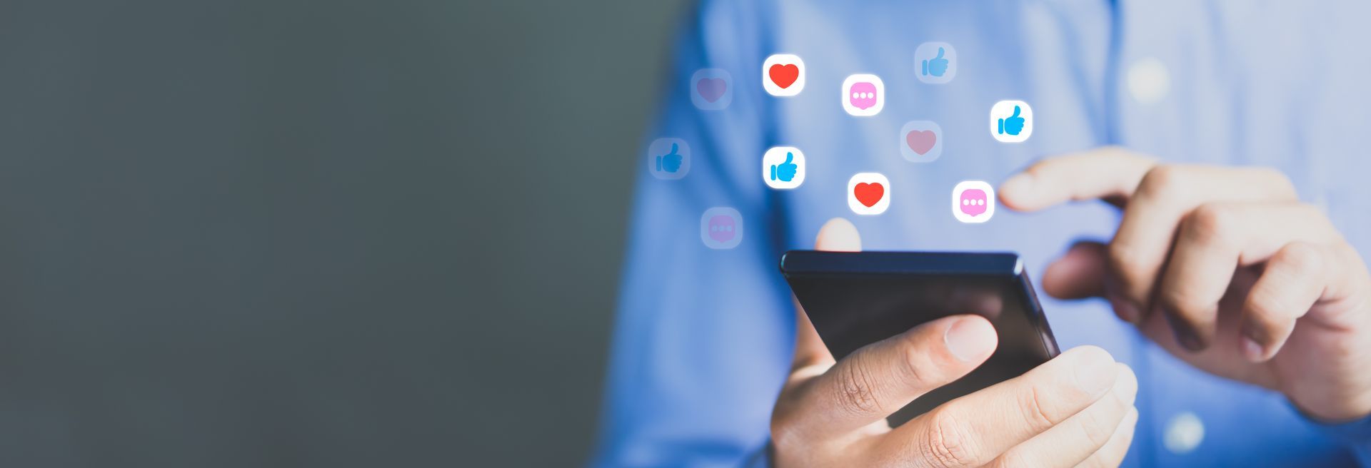 Someone holding phone showing social media icons coming out
