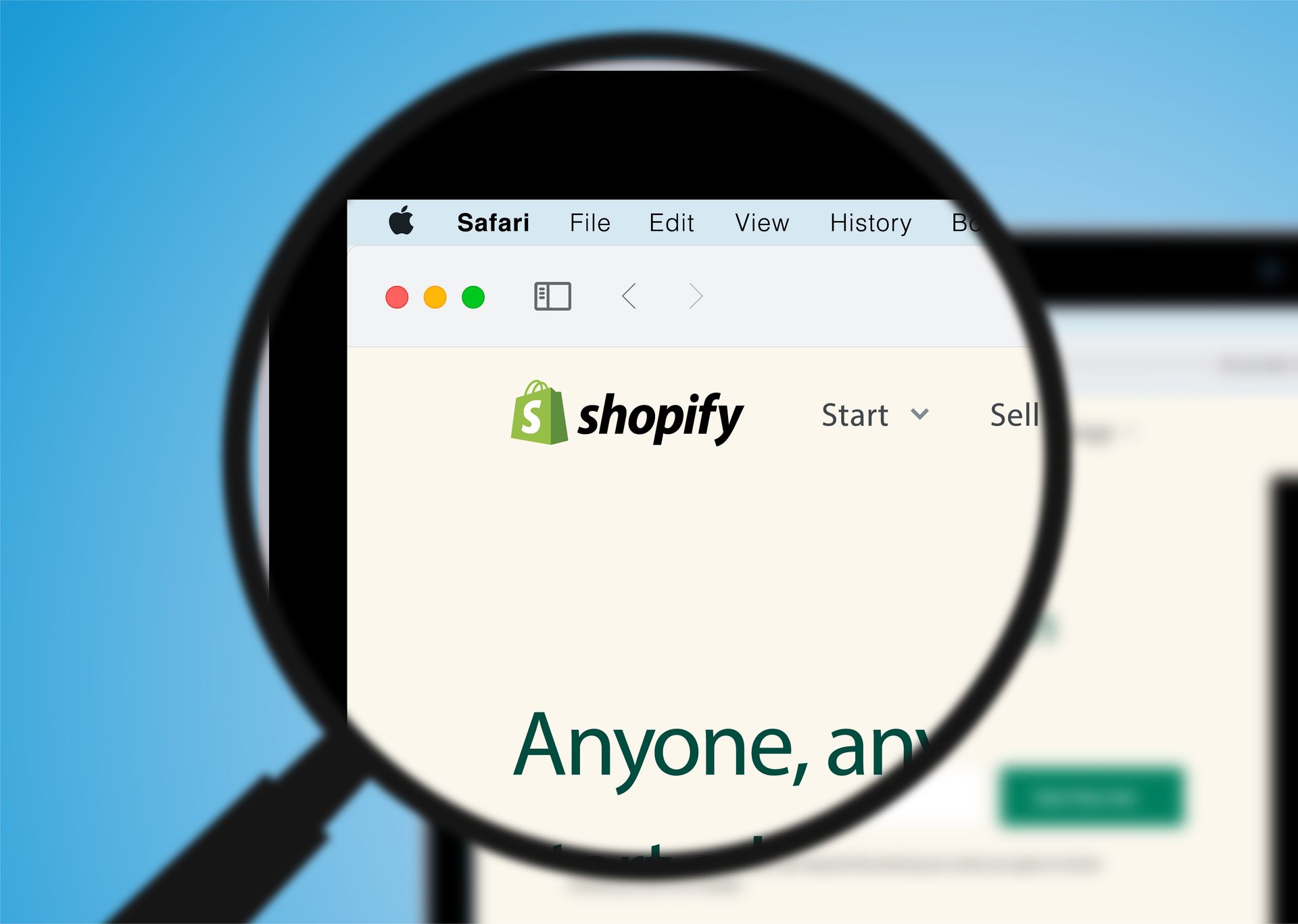 a magnifying glass is looking at a website called shopify