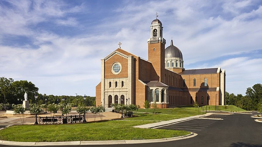 A large brick church with a dome on top of it
