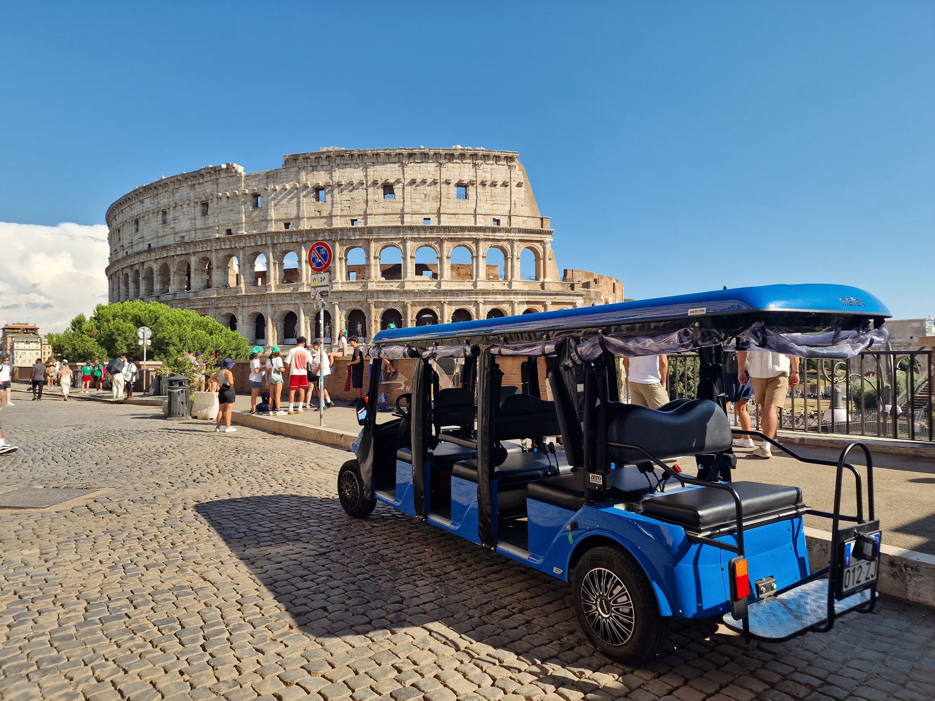 Golf cart in front of the Colosseum in Rome, Italy.