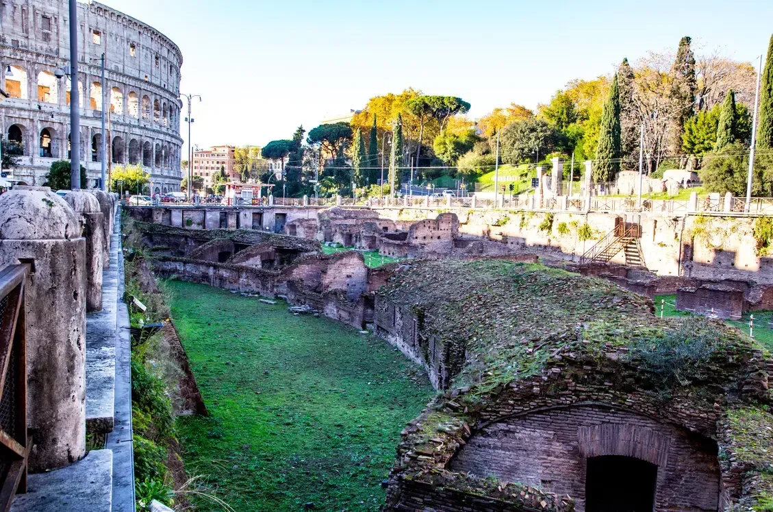 Colosseum exterior with sunlight shining through the arches.
