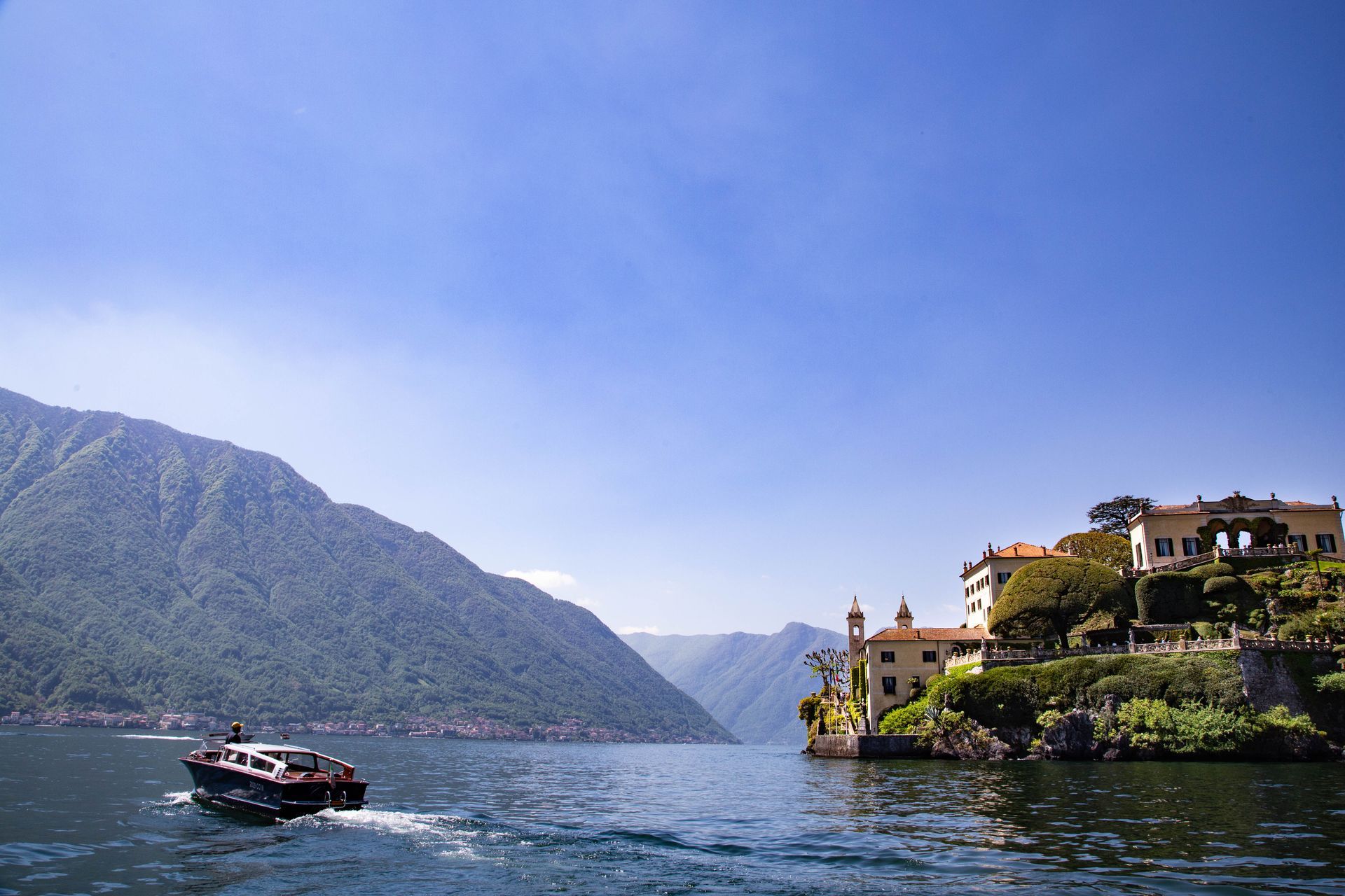 A boat passes Villa del Balbianello on Lake Como.